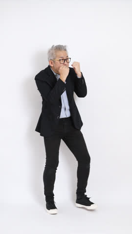 This is a portrait of an East Asian businessman with gray hair and glasses, dressed in a black suit, standing against a white background.