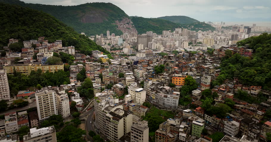 Favela Copacabana on hillside contrasts against city buildings in Rio de Janeiro