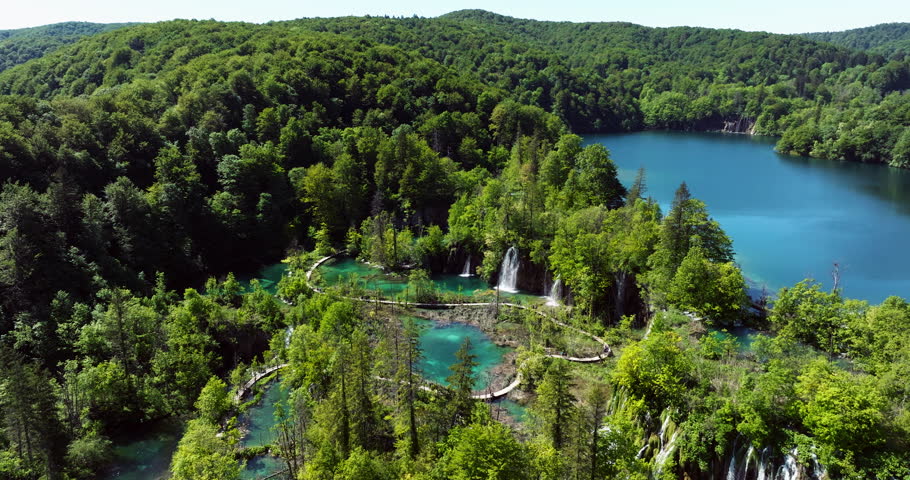 Plitvice Lakes National Park - Terraced Turquoise Lakes And Cascading Waterfalls Surrounded By Dense Green Forests. aerial orbiting shot