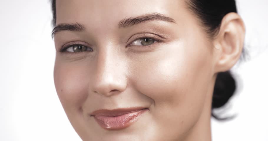Bright smile with white teeth and glowing skin in soft light. This closeup of a beautiful woman is ideal for dental care, skincare, beauty advertising, or health and wellness content.