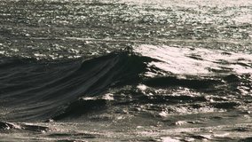 Golden backlit wave arcs and crashes in slow motion with textured sea surface reflecting light - Powered by Shutterstock - Get 15% off with code: PIKWIZARD15
