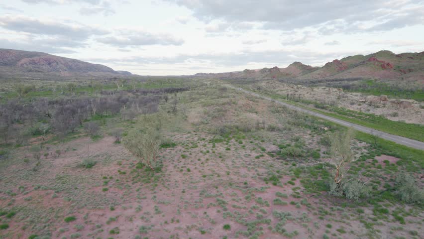 Travelling the Remote Australian Outback - Aerial Shot Following Paved Road From Above