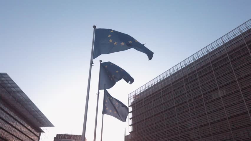 EU flags in front of the European Commission building in Brussels, Belgium