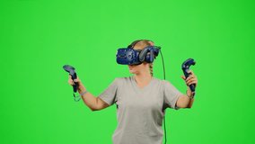 The girl wearing VR headset flying in virtual reality in video game. The woman gaming in virtual reality on chroma key green screen flying in space. Concept fly sport game VR headset virtual reality - Powered by Shutterstock - Get 15% off with code: PIKWIZARD15