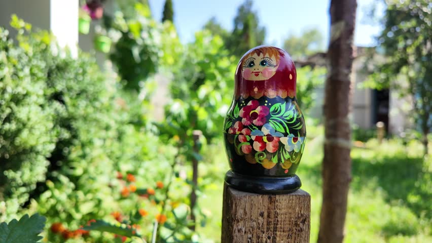 wooden matryoshka doll. Hand Holding a Wooden Matryoshka Doll – Traditional Russian Nesting Doll. Collection of traditional Russian nesting dolls. Beautiful handmade matryoshka dolls in a row.