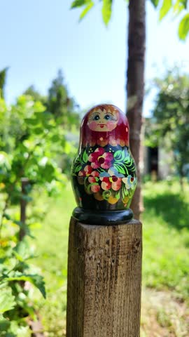 wooden matryoshka doll. Hand Holding a Wooden Matryoshka Doll – Traditional Russian Nesting Doll. Collection of traditional Russian nesting dolls. Beautiful handmade matryoshka dolls in a row.