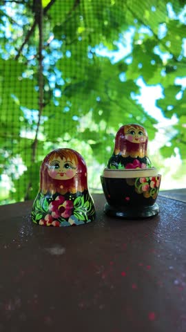 wooden matryoshka doll. Hand Holding a Wooden Matryoshka Doll – Traditional Russian Nesting Doll. Collection of traditional Russian nesting dolls. Beautiful handmade matryoshka dolls in a row.