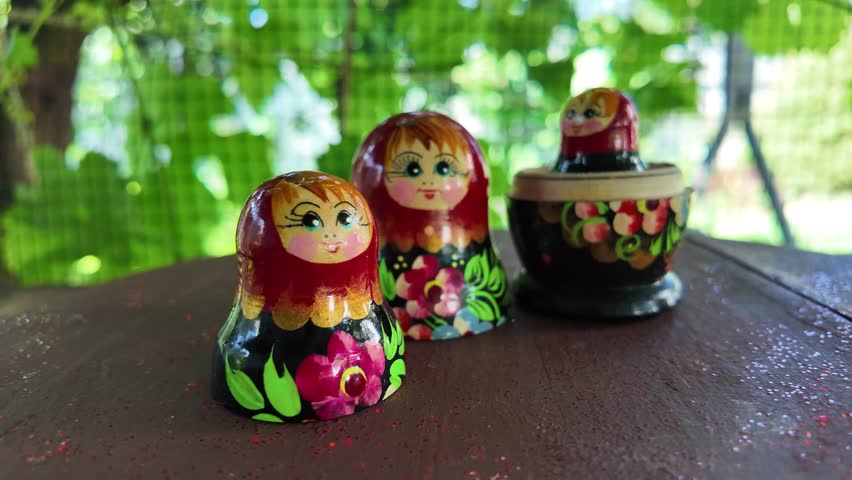 wooden matryoshka doll. Hand Holding a Wooden Matryoshka Doll – Traditional Russian Nesting Doll. Collection of traditional Russian nesting dolls. Beautiful handmade matryoshka dolls in a row.