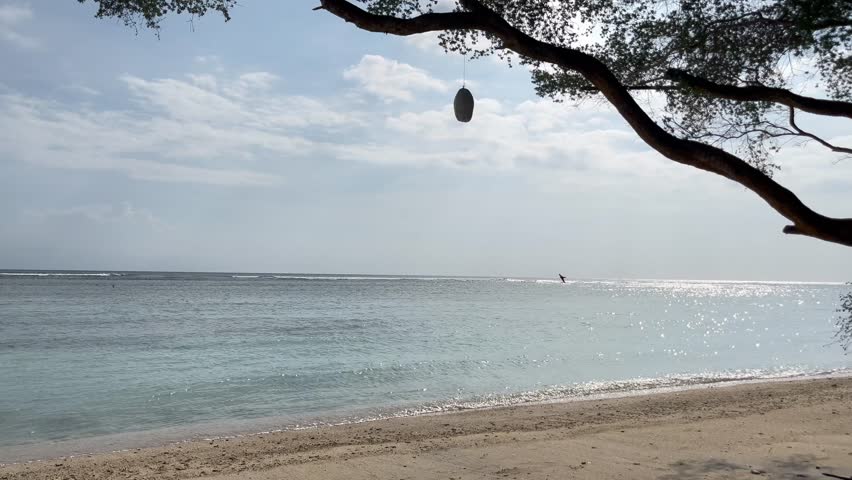Gili Trawangan 

The beach in Gili Trawangan is so quiet with the white sand and birds flying over the sea under a clear, partly cloudy sky, creating a peaceful and relaxing coastal atmosphere.