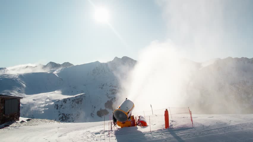 Snow cannon blowing fresh snow powder on the ski piste, aerial