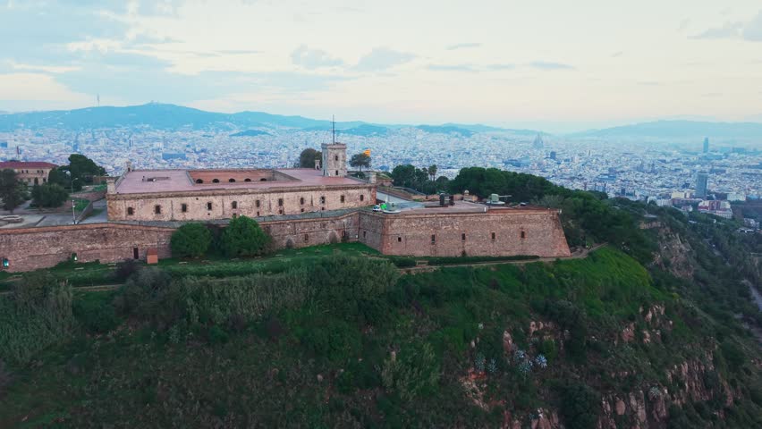 Montjuic castle on the hill above Barcelona, aerial push in