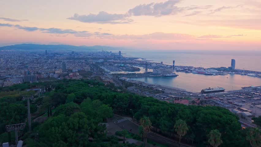 Aerial view of Barcelona with residential neighborhoods and city harbor, wide establisher