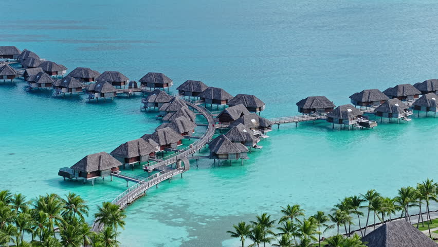Bora Bora, French Polynesia. Drone Shot of Overwater Bungalows and Turquoise Lagoon Water, Luxury Tropical Resort