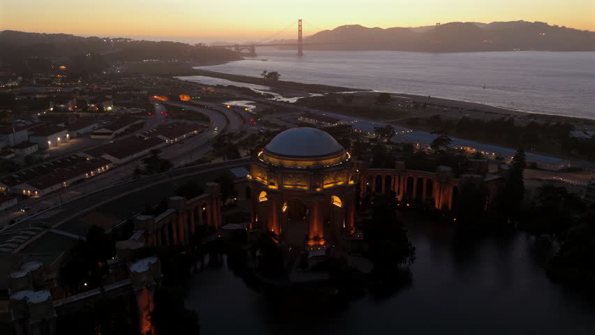 Experience the breathtaking aerial footage captured over San Franciscos stunning Bay Area, showcasing the beautiful Palace of Fine Arts and the iconic Golden Gate Bridge during the enchanting sunset