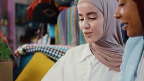 Muslim fashion designers collaborating in atelier, reviewing dress design  while discussing creative details and business strategy to sell clothes and accessories online. - Powered by Shutterstock - Get 15% off with code: PIKWIZARD15