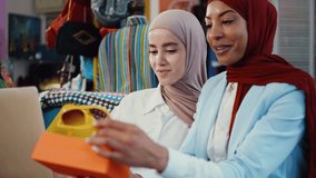 Muslim fashion designers collaborating in atelier, reviewing dress design  while discussing creative details and business strategy to sell clothes and accessories online. - Powered by Shutterstock - Get 15% off with code: PIKWIZARD15