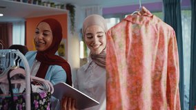 Muslim fashion designers collaborating in atelier, reviewing dress design  while discussing creative details and business strategy to sell clothes and accessories online. - Powered by Shutterstock - Get 15% off with code: PIKWIZARD15