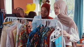 Muslim fashion designers collaborating in atelier, reviewing dress design  while discussing creative details and business strategy to sell clothes and accessories online. - Powered by Shutterstock - Get 15% off with code: PIKWIZARD15