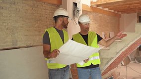 Video of two Construction workers analyzing blueprints and discussing project details on a construction site - Powered by Shutterstock - Get 15% off with code: PIKWIZARD15