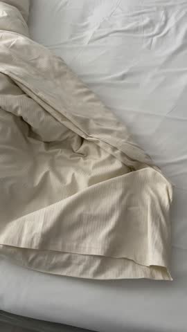 bed, messy bed with white bedding sets in a bedroom of a house or hotel room. home interior concept 4k vertical video with untidy bedroom. unmade bed with wrinkle messy blanket in bedroom, from sleep