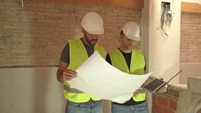 Video of male engineer and foreman wearing safety hardhat and vest reviewing blueprints at the construction site - Powered by Shutterstock - Get 15% off with code: PIKWIZARD15