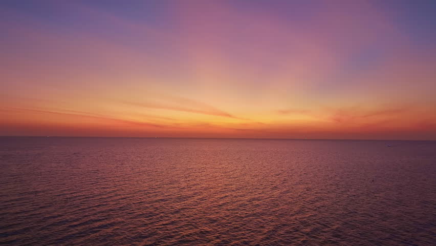 Colorful sunset or sunrise above the sea surface Aerial view drone fly over open sea Sunset over ocean Amazing nature background 4K Video High quality ProRes