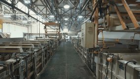 A view inside a large industrial facility with automated machinery and metal structures lining both sides of the walkway, showing advanced manufacturing or processing operations in progress.
 - Powered by Shutterstock - Get 15% off with code: PIKWIZARD15