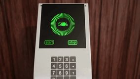 A modern electric car charging station displays % charge on its digital screen. The sleek interface shows progress with a green circular gauge, along with start and stop buttons for user control. - Powered by Shutterstock - Get 15% off with code: PIKWIZARD15