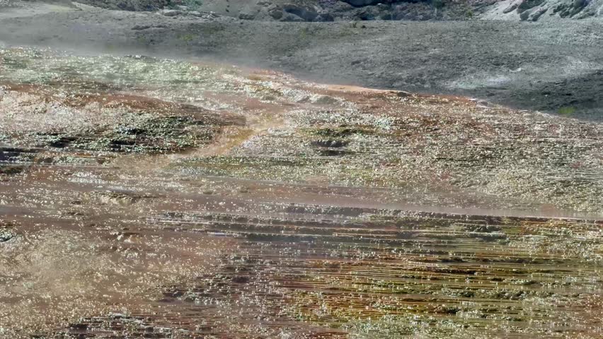 Close up view of hot water running over colourful limestone rocks on the Travertine Terraces at the Mammoth Hot Springs in Yellowstone National Park, Wyoming. 