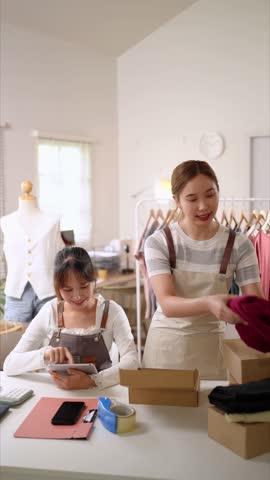 Entrepreneurs collaborate on ecommerce logistics and order fulfillment while managing a stylish boutique brand