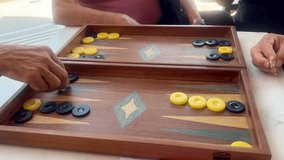 Backgammon, 4K Video of Male Hands Rolling Dices for Playing Traditional Greek Backgammon. male players engaging in a game of Greek backgammon tavli in Greece. social leisure in Mediterranean culture - Powered by Shutterstock - Get 15% off with code: PIKWIZARD15