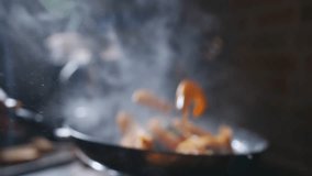 A pan of food is cooking on a stove, with steam rising from it. The steam is thick and white, and the food is orange - Powered by Shutterstock - Get 15% off with code: PIKWIZARD15