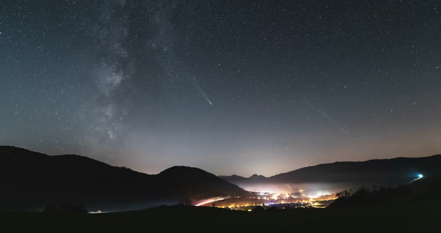Starry Night Sky with Milky Way Galaxy Stars and Comet Tsuchinshan Atlas over Countryside Traffic Astronomy Time lapse