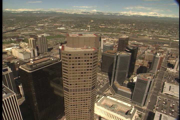 DENVER - CIRCA MAY 1995: Aerial over tall buildings and skyscrapers of downtown Denver.
