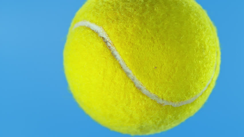 Super Slow Motion of Tennis Ball Hitting Camera on Blue Screen, 1000 fps.
