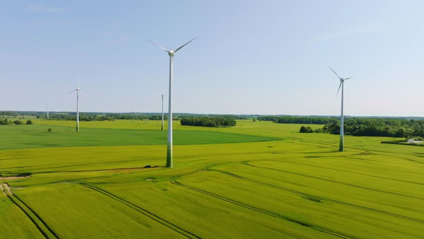 Drone captures silent inactive wind turbines over green farmland in Latvia
