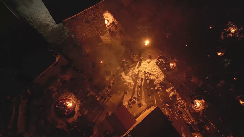 Aerial zoom out view Lamproba festival, villagers gathered by symbolic bonfires near church and medieval tower in Mestia, Svaneti.Concept welcoming arrival of spring, invite the blessings of the gods