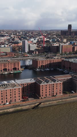 Vertical aerial view of the Royal Albert Dock in Liverpool. Establishing shot of skyline and iconic landmark