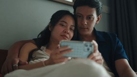 Happy couple relaxing in bed, using smartphone together - Powered by Shutterstock - Get 15% off with code: PIKWIZARD15