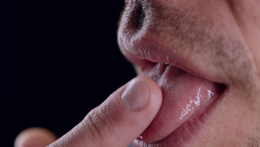 Man Licking Finger Demonstrating Bacterial Transmission Risk