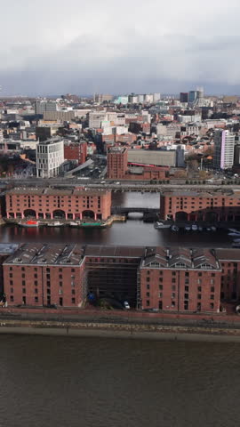 Vertical aerial view of the Royal Albert Dock in Liverpool. Establishing shot of skyline and iconic landmark