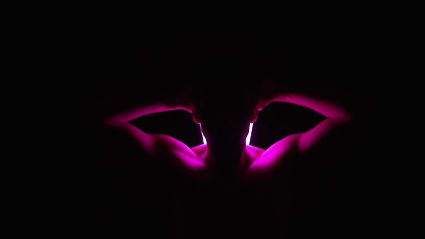 Bare-Chested Man Drawing Two Glowing Neon Tubes from His Back