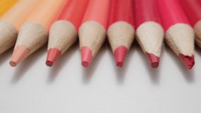 Close-Up of Vibrant Warm-Toned Colored Pencils Lined Up on a White Surface in Soft Light - Powered by Shutterstock - Get 15% off with code: PIKWIZARD15