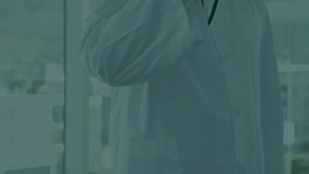 Senior male doctor lifting stethoscope by window creating medical hologram gear icons scattering. Technology, innovation, healthcare, futuristic, digital, biomedical, visualization - Powered by Shutterstock - Get 15% off with code: PIKWIZARD15