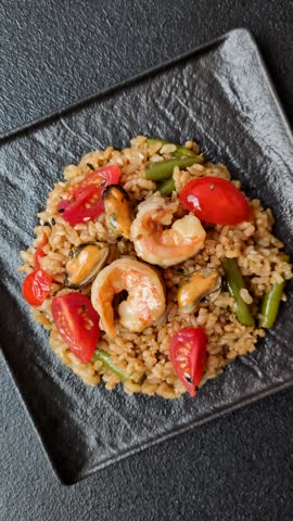 Rice and prawns or paella, a meal with seafood and vegetables. Cooked rice with shrimp, asian or Spanish food