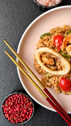 Rice and prawns or paella, a meal with seafood and vegetables. Cooked rice with shrimp, asian or Spanish food