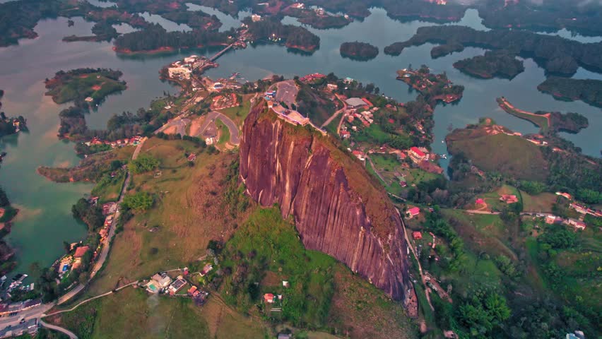 Aerial view of La Piedra del Peñol monolith and lake at sunset – Guatapé, Medellín, Colombia