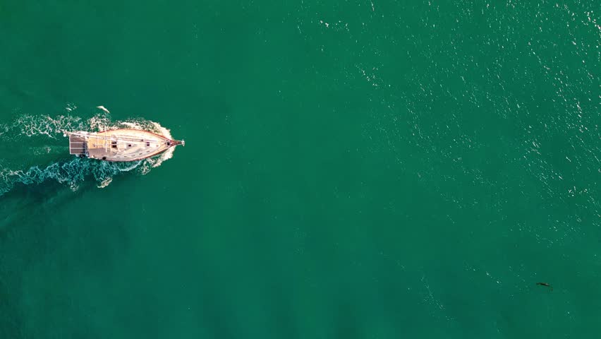 Sailing and yachting tourism. Luxury lifestyle. Summer vacation. Aerial top sea sail boat. Sailing at sea. Sailboat top view. Sailboat sailing in sea. Boat going to yacht marina. Ocean breeze ride