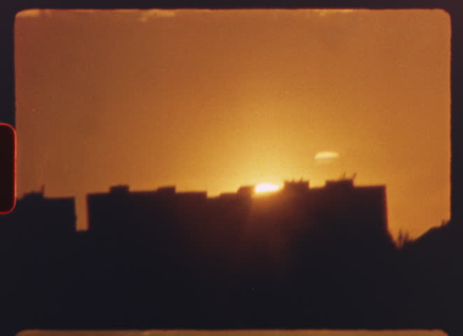 8 mm film - warm orange and red colors dominate the six separate shots of a setting sun, with silhouettes of landscapes and urban structures visible in the foreground