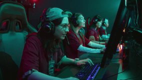 Medium side shot of team of four multiethnic female gamers participating in online shooter video game championship, shouting during final moments, winning and celebrating victory with high fives - Powered by Shutterstock - Get 15% off with code: PIKWIZARD15
